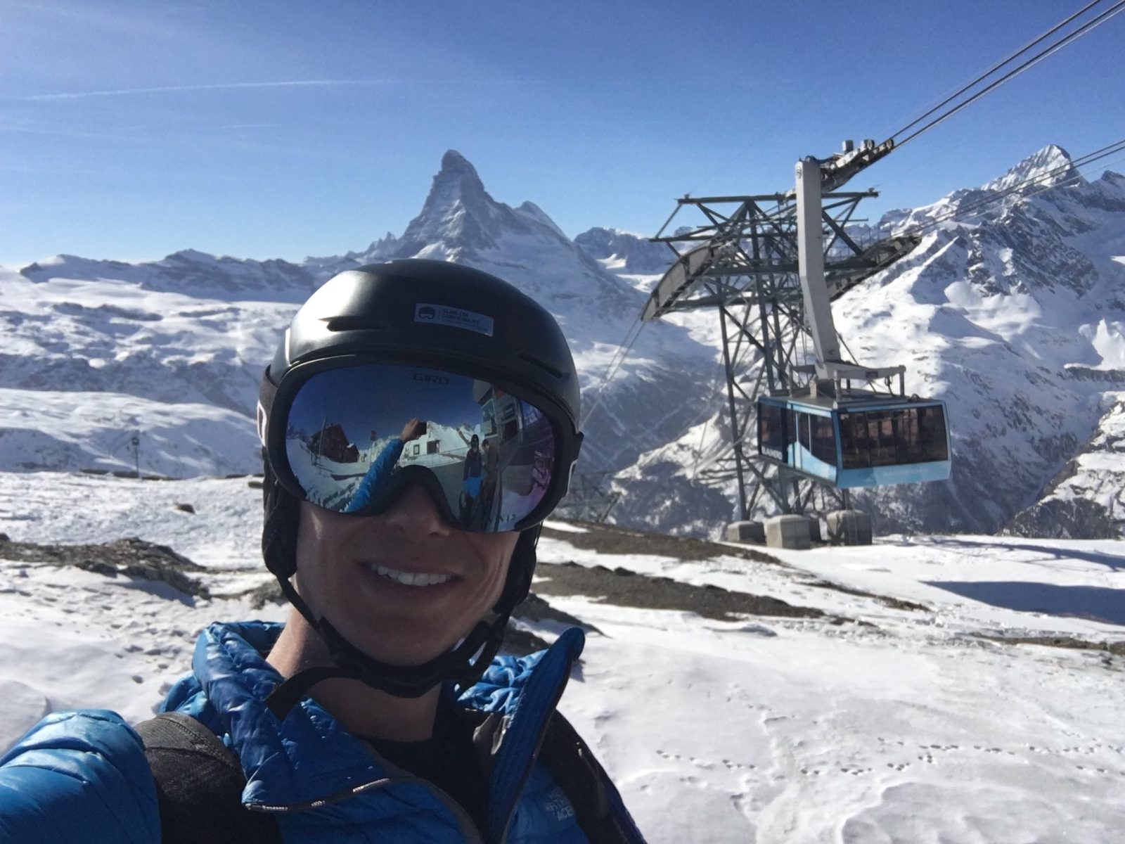 Josh Lake at Moraine Lake wearing MIT hoodie, surrounded by pine trees and mountains