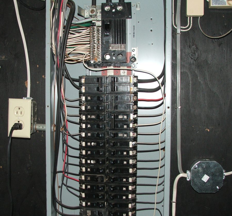 A full residential GE electrical breaker panel with every slot used